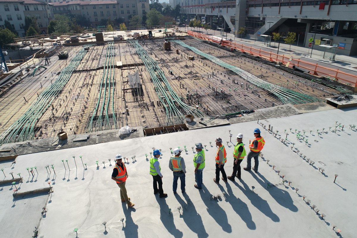 Construction team reviewing a steel-reinforced building site